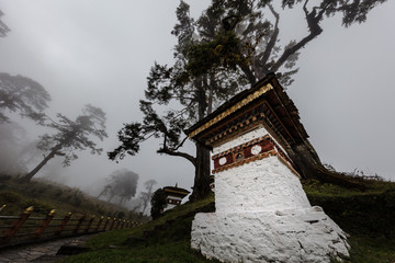 Druk Wangyal, Bhutan, 108 chorten or stupas, a memorial in honor of the Bhutanese soldiers at the Dochula Pass on a cloudy foggy day in altitude of 3000 meters. A bhutanese sanctuary