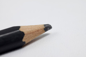 Graphite wooden pencil on an isolated white background