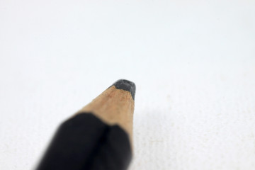 Graphite wooden pencil on an isolated white background