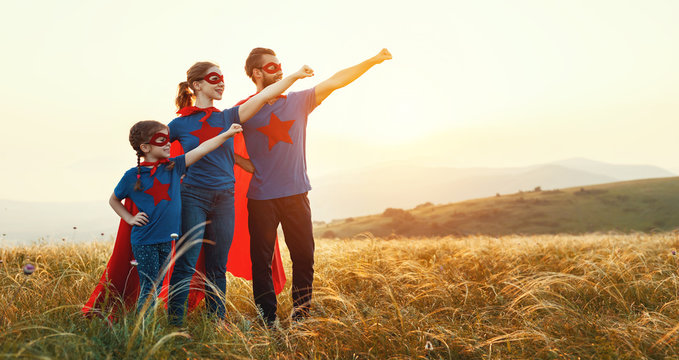 concept of super family, family of superheroes at sunset .