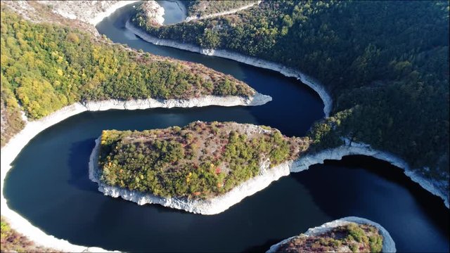 Forward moving drone over curvaceous Uvac river under Golija mountain and Pester plateau. Serbia.