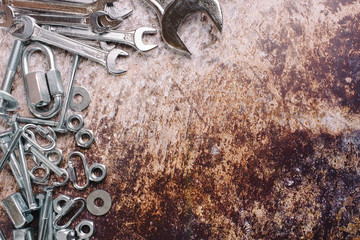 bolts, nuts, carabiner and wrenches, top view, place for text. construction concept