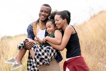 African American Family Looking very Happy outdoors.