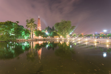Tran Quoc oldest Buddhist temple reflection on West Lake in Hanoi at blue hour