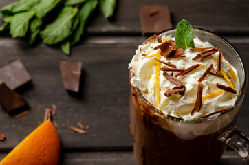 Hot Chocolate with cream in Tall Glass on black background