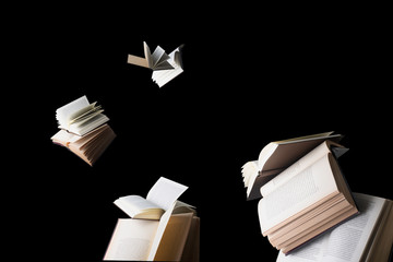 Flying books isolated on black