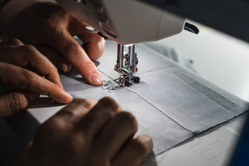 Seamstress teacher teaching a young student