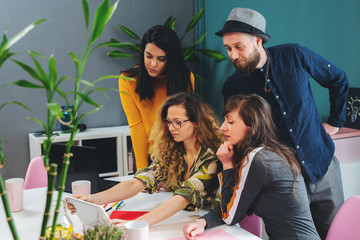 Business Team Working In Office Developing Creative Ideas For Successful Startup. Productive business people in trendy hipster office discussing new ideas