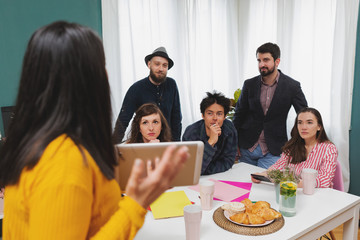 Business Woman Team Leader Sharing Ideas In Office Training Presentation Seminar.Yong business woman presenting new leadership ideas at meeting with colleagues in modern office.