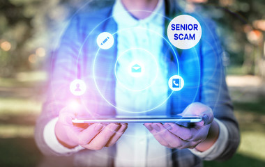 Writing note showing Senior Scam. Business concept for fraud schemes targeting the lifestyle and savings of the elderly