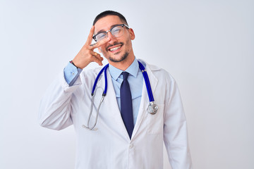 Young doctor man wearing stethoscope over isolated background Doing peace symbol with fingers over face, smiling cheerful showing victory