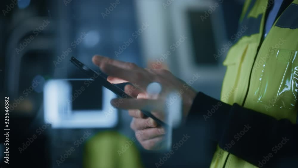 Aufkleber Professional Engineer Wearing Safety Vest Uses Digital Tablet Computer. Slow Motion Focus on Hands Using Gestures. Working in Industrial Facility with High Tech Machinery.