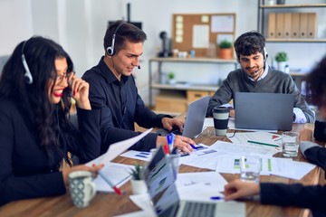 Group of call center workers smiling happy and confident. Working together with smile on face using headset at the office.