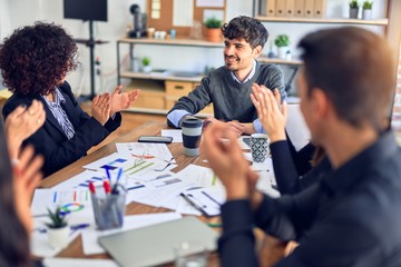 Group of business workers smiling happy and confident. Working together with smile on face applauding one of them at the office