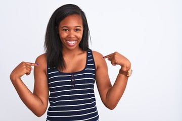 Beautiful young african american woman wearing summer t-shirt over isolated background looking...