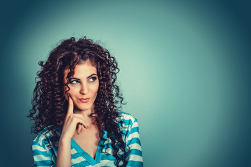 Daydreaming. Young beautiful playful curly woman thinking