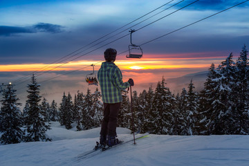 Adventurous Girl Skiing on a beautiful snowy mountain during a vibrant and sunny winter sunset....