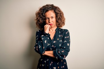Fototapeta premium Middle age beautiful woman wearing casual dress standing over isolated white background thinking looking tired and bored with depression problems with crossed arms.