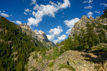 Fototapeta premium Clouds and Blue Sky Over Jagged Peaks of Tetons