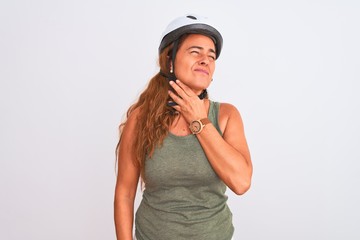 Middle age mature cyclist woman wearing safety helmet over isolated background Touching painful neck, sore throat for flu, clod and infection
