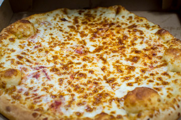 Opened box of cheese pizza