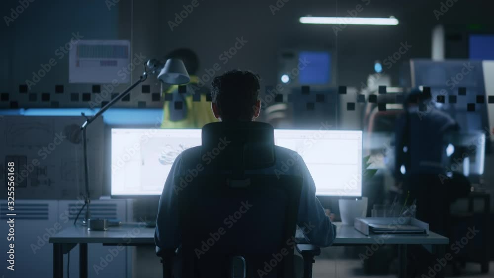 Poster Industrial Engineer Solving Problems, Working on a Personal Computer, Two Monitor Screens Show CAD Software with 3D Prototype of Eco-Friendly Electric Engine Concept. Back View Zoom in