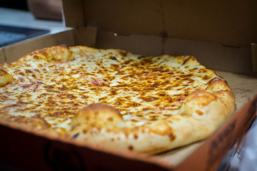 Opened box of cheese pizza
