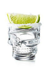 Skull Shaped Tequila Glass Shot With Lime Slice and Salty Rim, Isolated on White Background