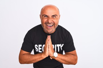 Middle age safeguard man wearing security uniform standing over isolated white background begging...