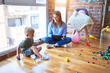 Young therapist woman speaking with child, counselor and behaviour correction at the office around toys