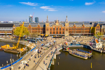  Aerial view of the central train station in Amsterdam which is the oldest station in the Netherlands. - obrazy, fototapety, plakaty
