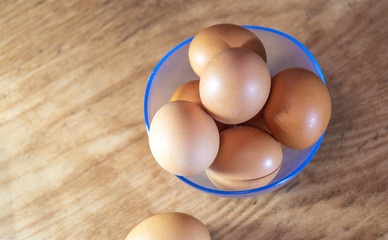 Chicken eggs arranged in a jar on a wooden background