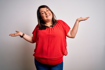 Beautiful brunette plus size woman wearing casual red t-shirt over isolated white background...
