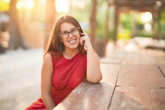 Young beautiful girl smiling happy and confident walking at the town park, standing with a smile on face