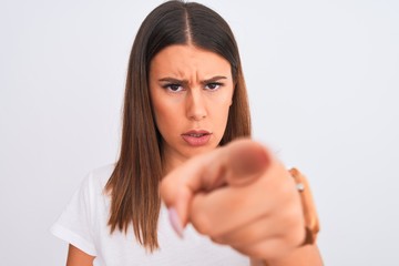 Close up of beautiful and young brunette woman standing over isolated white background pointing with finger to the camera and to you, hand sign, positive and confident gesture from the front