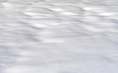Obraz premium snow drift covered ground texture with shadows