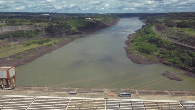 Tourism bus crossing the road above the Parana River. Itaipu dam 
