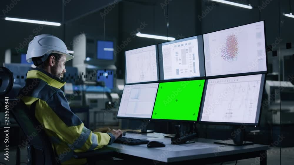 Poster Industry 4.0 Modern Factory: Handsome Male Operator Controls Facility, Uses Computer with Multiple Screens Including: Green Screen / Chroma Key, AI Concept, Machine Learning UI
