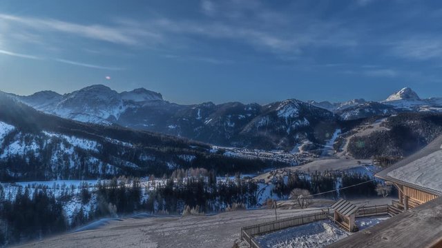 A full day timelapse of the sky and the valley near the town of Al Plan in South Tyrol, Italy. The sun is moving on the sky lighting the valley below, white clouds whirling and disappearing.