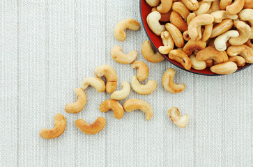 Cashew nuts roasted salt on tablecloth.