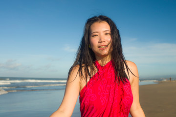 Fototapeta na wymiar young sweet and happy Asian Chinese woman in sarong at beautiful beach walking by the sea relaxed and blissful enjoying Summer holiday travel feeling free in Asia travel