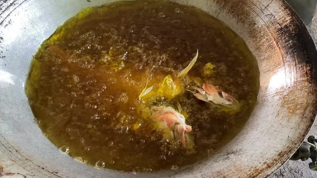 Deep fried red snapper fish in boiling oil pan