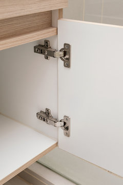 detail of concealed hinge on cabinet door, furniture fitting hardware for cupboard or wardrobe