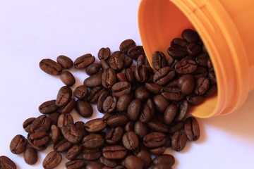 Coffee beans in coffee container isolated on white. Brown of Roasted coffee beans with background. roasted coffee beans. Isolated on a white background.