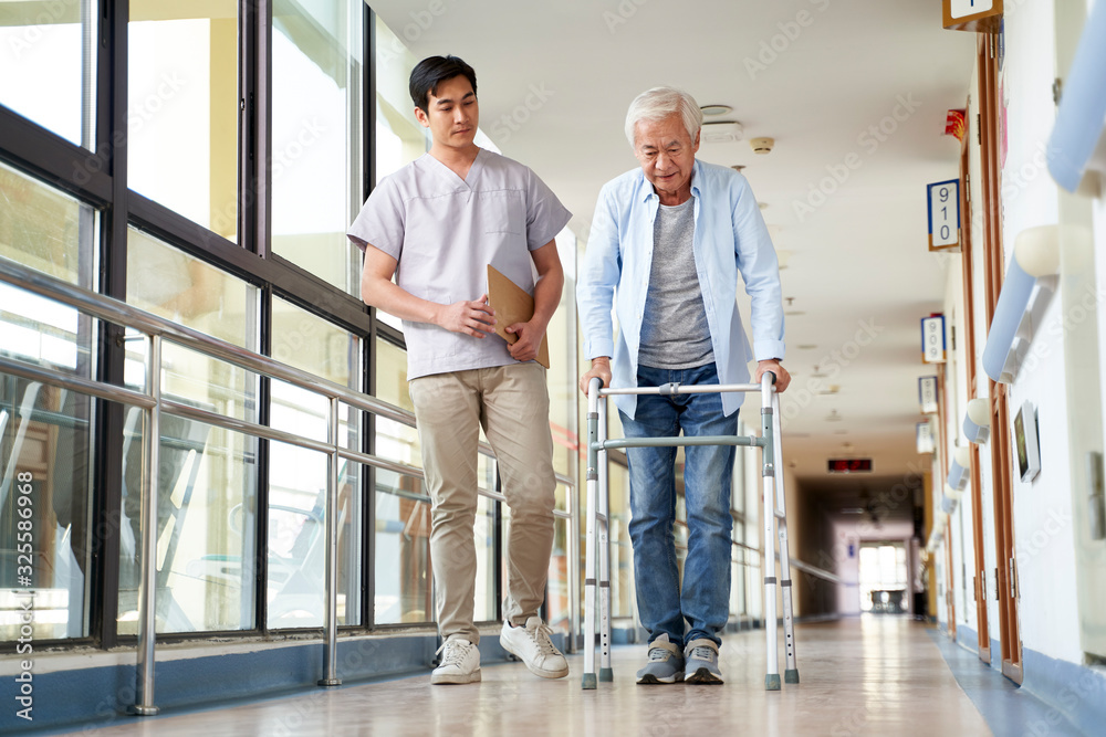 Wall mural asian old man walking with a walker in rehab center