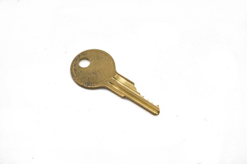 A brass cam lock key, close up, isolated on a clean, white background.  Shot in macro.