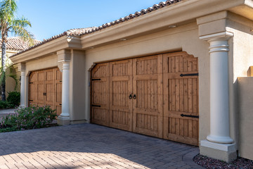 Custom wood garage door with grooves and barn door style decorations