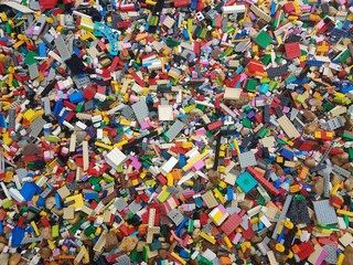 colorful plastic building blocks and rocks or stones