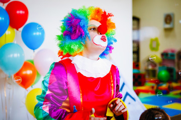 Children play with a clown