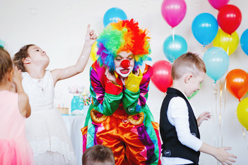 Children play with a clown